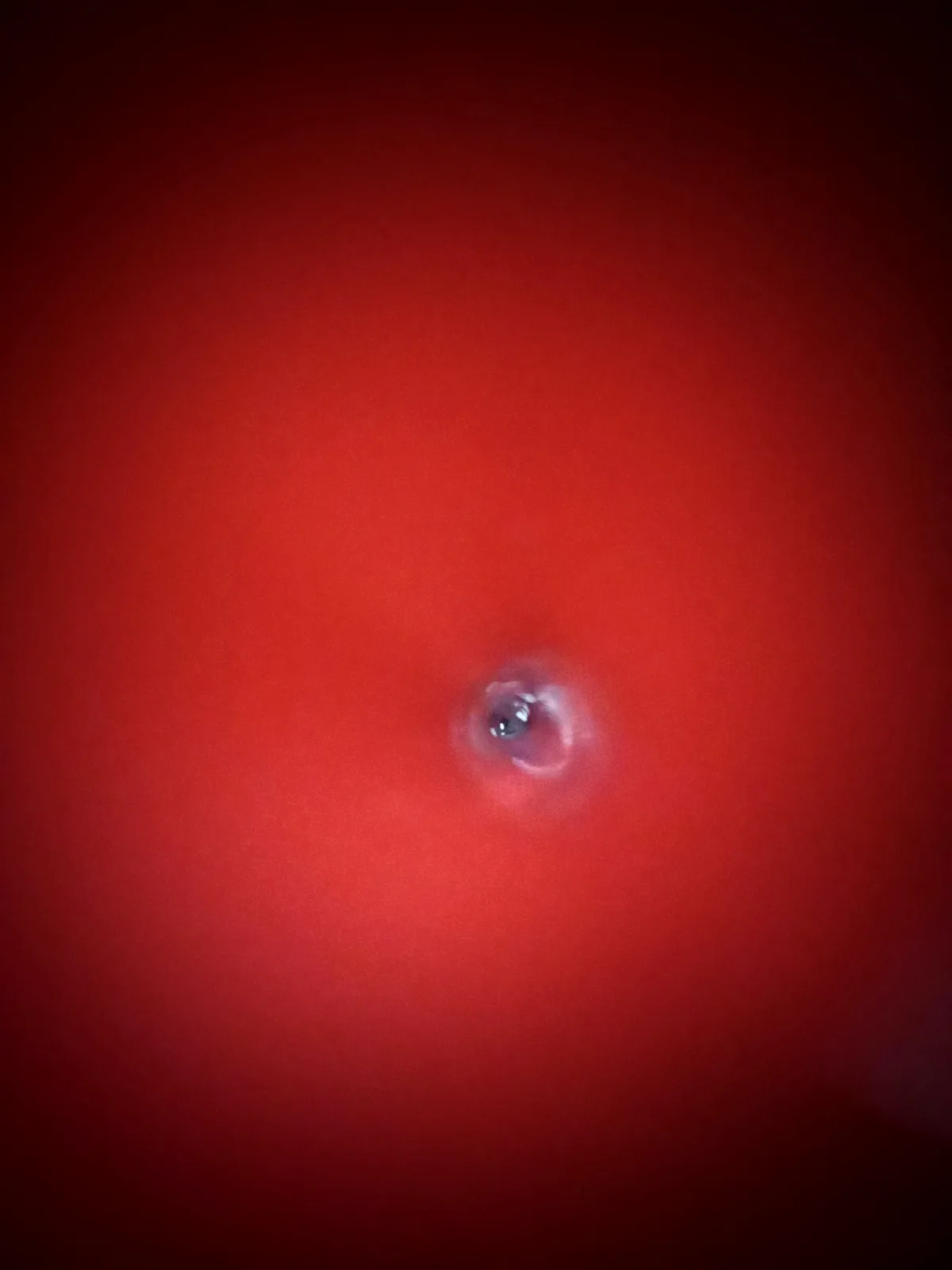 A close-up photo shows a single, glistening tear on a red surface, likely skin, with the overlaid text 'i'm not crying…