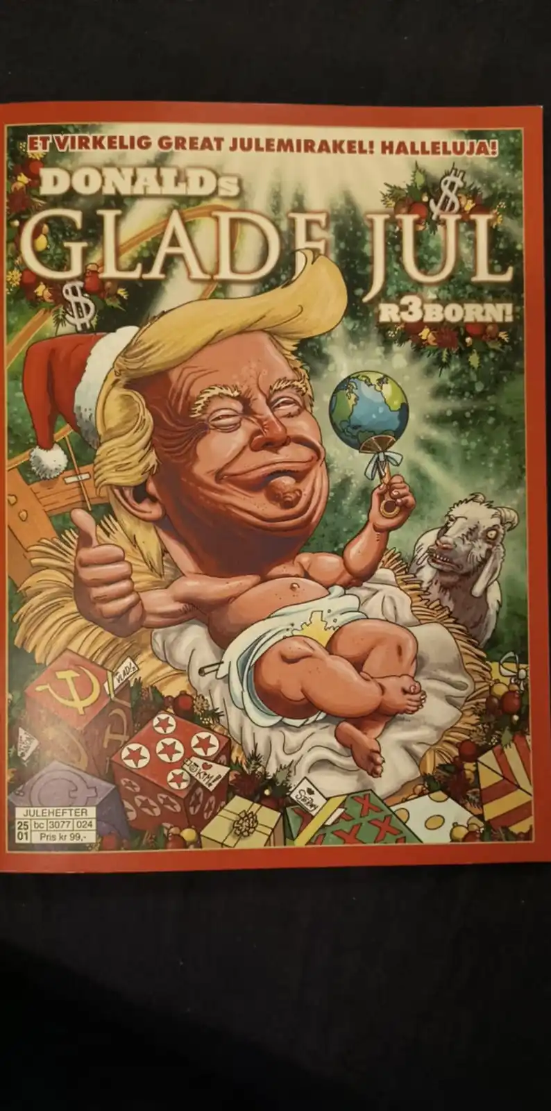 A satirical Christmas comic cover shows a caricature of Donald Trump as a baby in a nativity scene, wearing a Santa hat and…