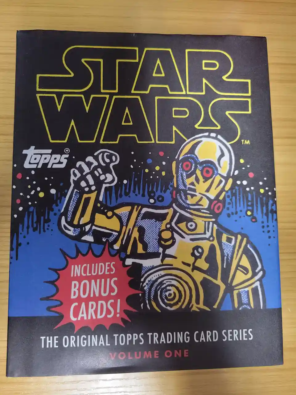 A vintage Star Wars Topps trading card series volume one box featuring a stylized illustration of the droid C-3PO. The box…