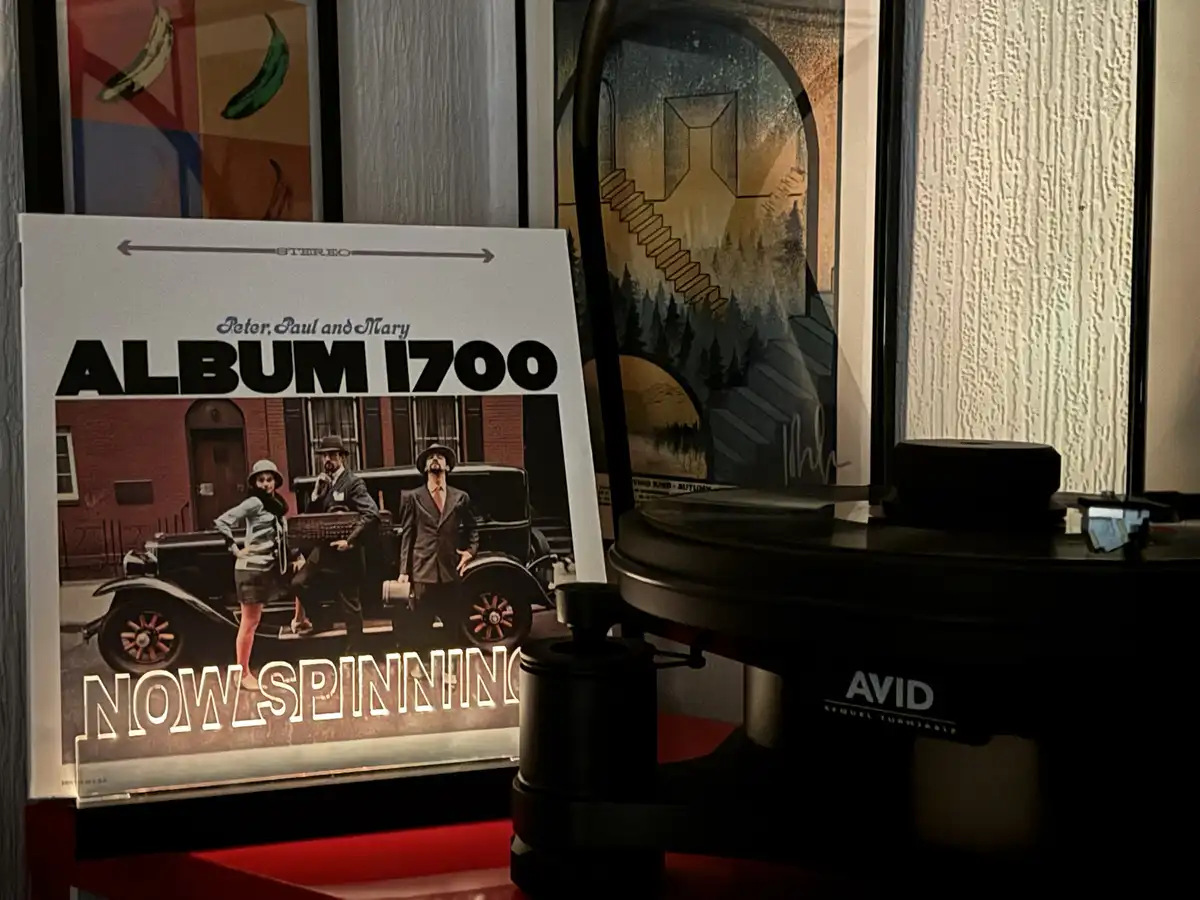 A vinyl record player with an 'AVID Sequel Turntable' is shown next to a record sleeve for 'Peter, Paul and Mary' titled…
