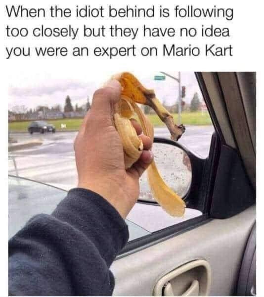 A person's hand holds a banana peel outside a car window, implying they're about to use it as a prank or distraction. The…