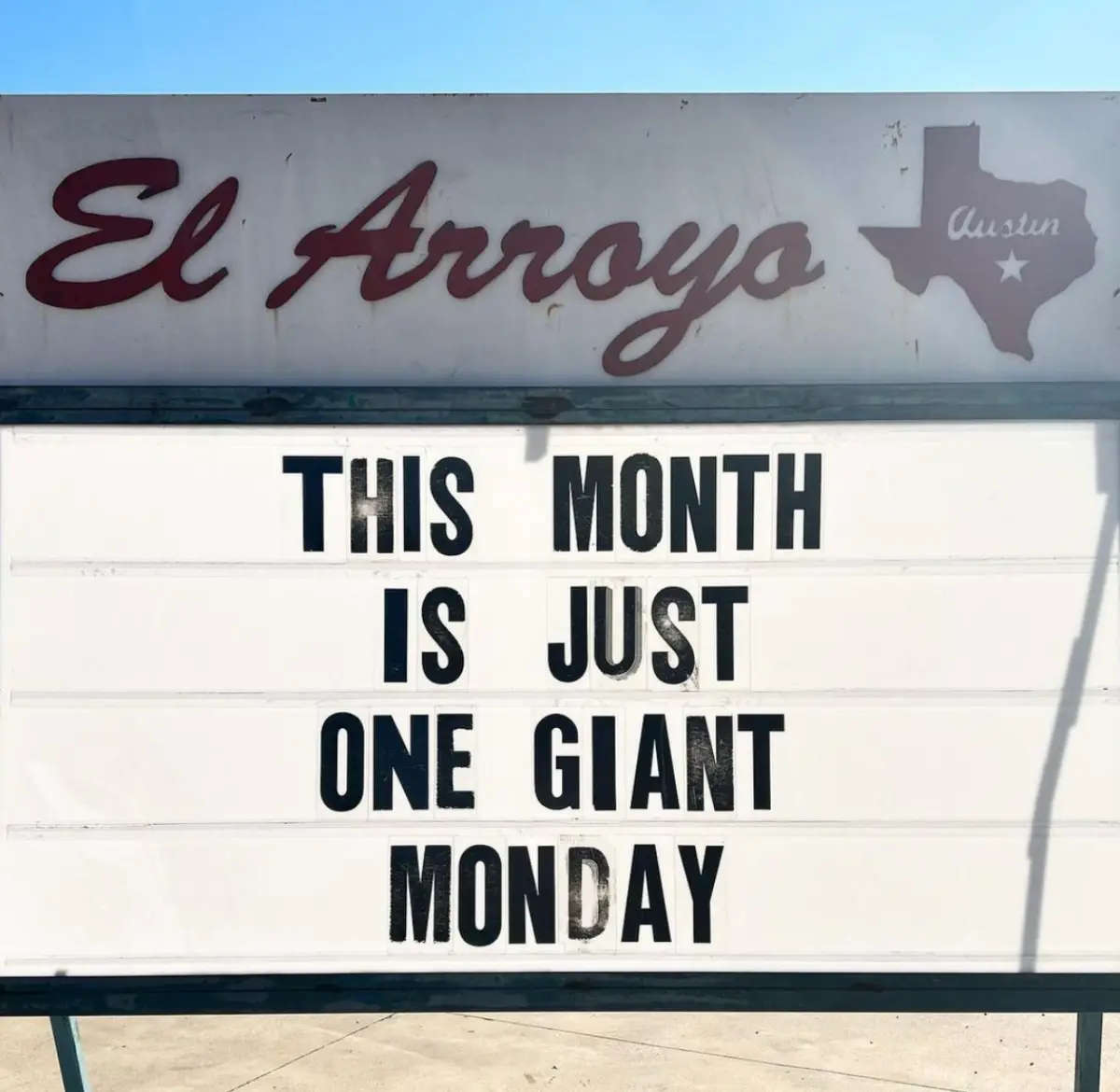 A white marquee sign for 'El Arroyo' in Austin, Texas, displays the text 'THIS MONTH IS JUST ONE GIANT MONDAY' in bold black…