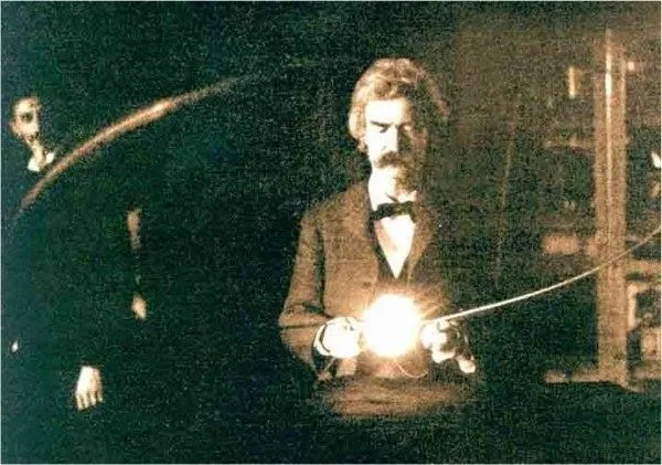 A sepia-toned historical photo shows a man with a mustache and bow tie holding a glowing object, with another person…