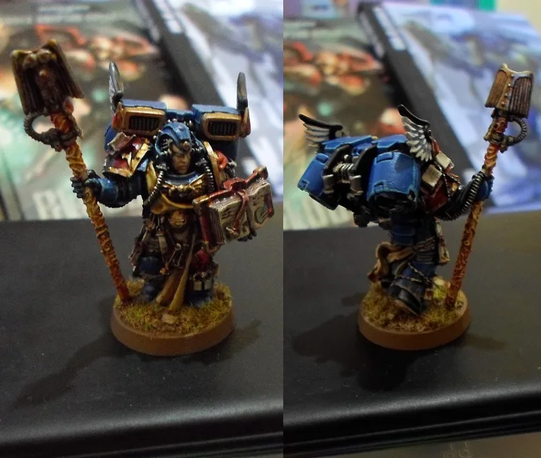 A split image shows a painted miniature of a Space Marine holding a book in both panels, but in the right panel, the figure…