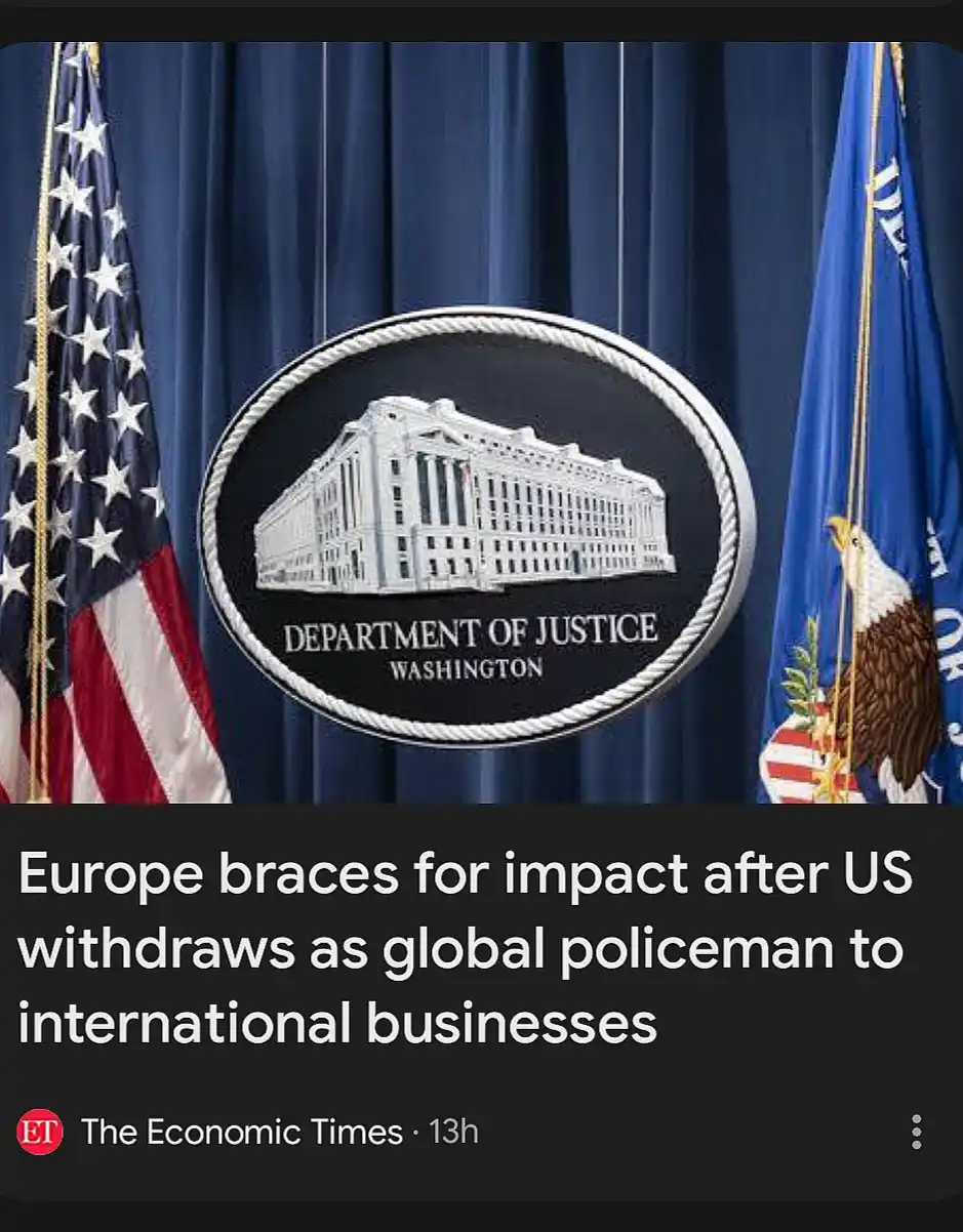 The image shows the official seal of the U.S. Department of Justice centered on a blue curtain, flanked by the American flag…