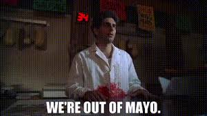 A man in a white shirt stands in a dimly lit kitchen holding a red object, with overlaid text reading 'WE'RE OUT OF MAYO.'…