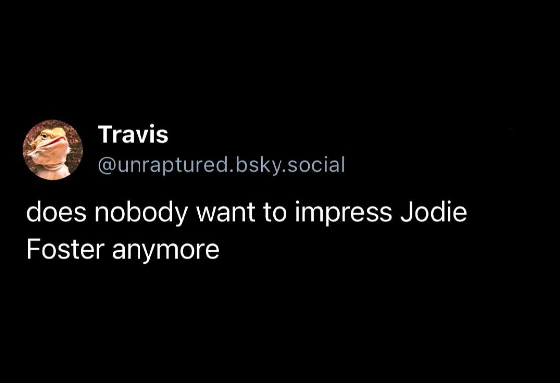 A screenshot of a social media post by a user named Travis, whose profile picture is a close-up of a bearded dragon with its…