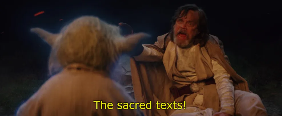 A still from Star Wars shows Luke Skywalker, with a shocked expression and mouth open, pointing at Yoda who is seen from…
