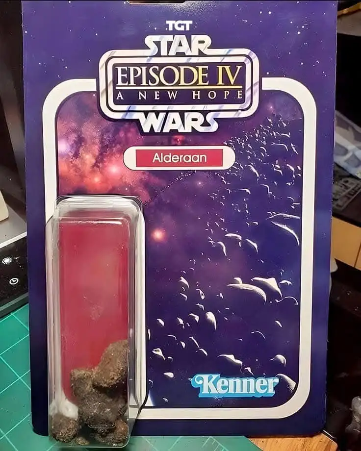 A vintage Star Wars action figure card from Kenner for Alderaan, but instead of a toy, the blister pack contains actual…