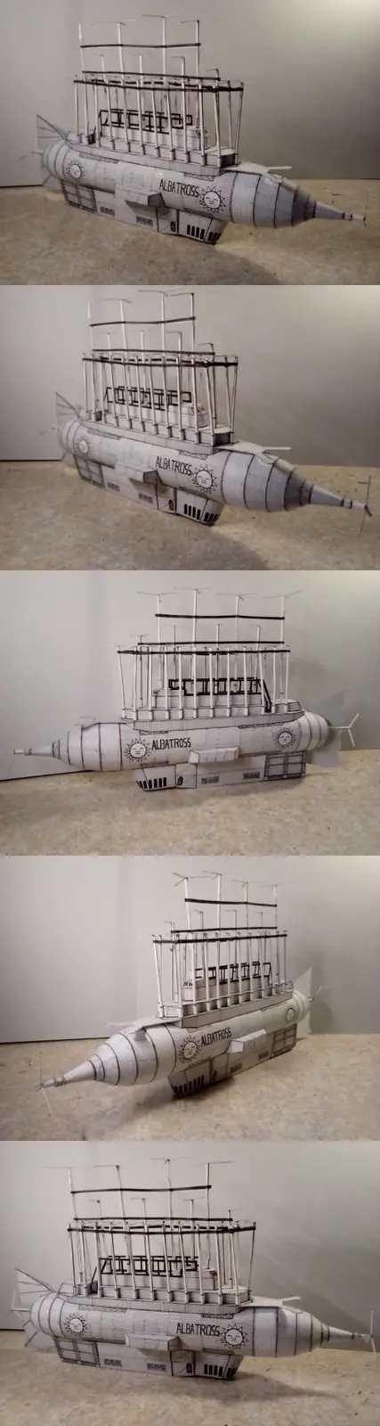 A composite image shows five different angles of a detailed paper model of a submarine named 'ALBATROSS', featuring a…