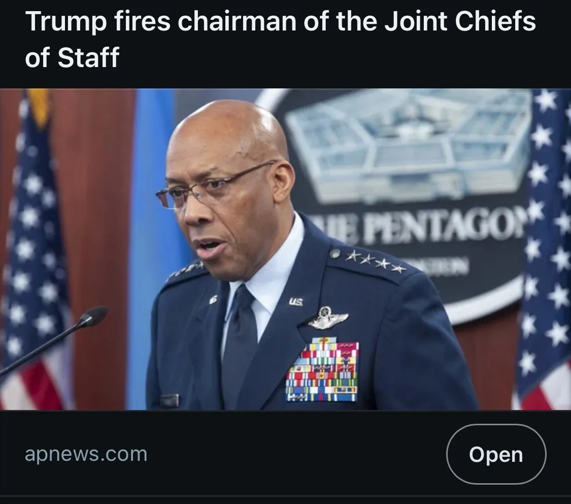 A photo of a Black man in a U.S. Air Force general's uniform with four stars, speaking at a podium in front of a Pentagon…