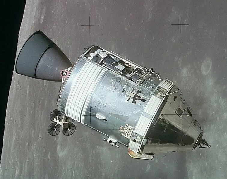 A vintage photograph shows the Apollo Lunar Module on the moon's surface, with its landing gear deployed and the 'UNITED…