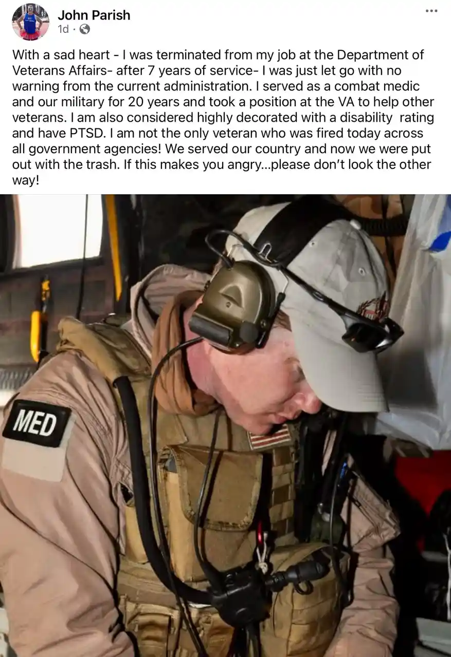 A man in military-style gear, including a tan vest with a 'MED' patch on the shoulder and a headset, is shown with his head…