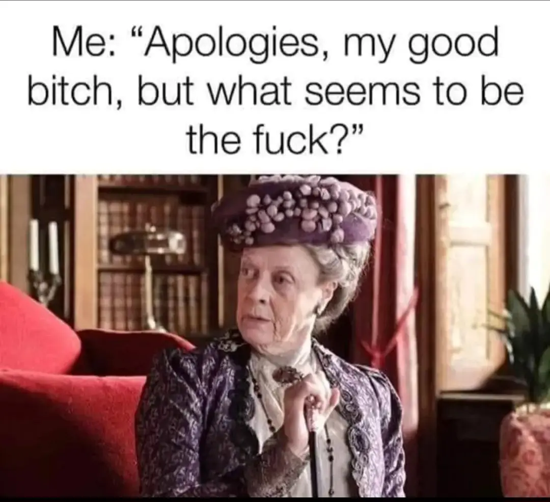 An elderly woman in a purple hat and ornate dress sits in a red chair, looking confused and slightly annoyed. The overlaid…