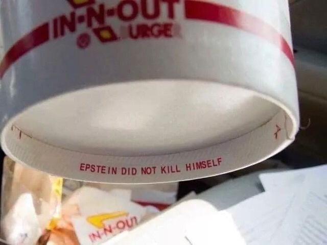 A close-up photo of an In-N-Out Burger paper cup, showing the brand logo and the phrase 'EPSTEIN DID NOT KILL HIMSELF'…