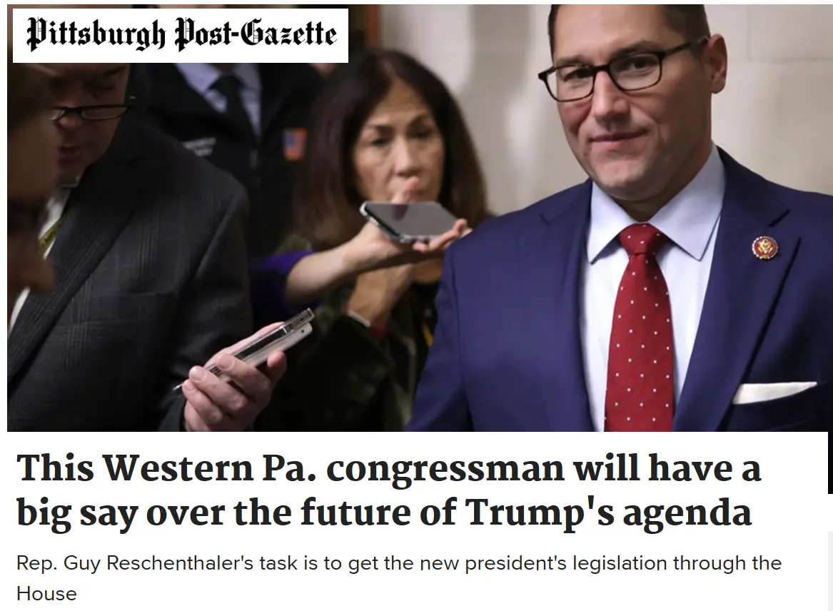 A photo from the Pittsburgh Post-Gazette shows Rep. Guy Reschenthaler in a blue suit and red tie, smiling while surrounded…