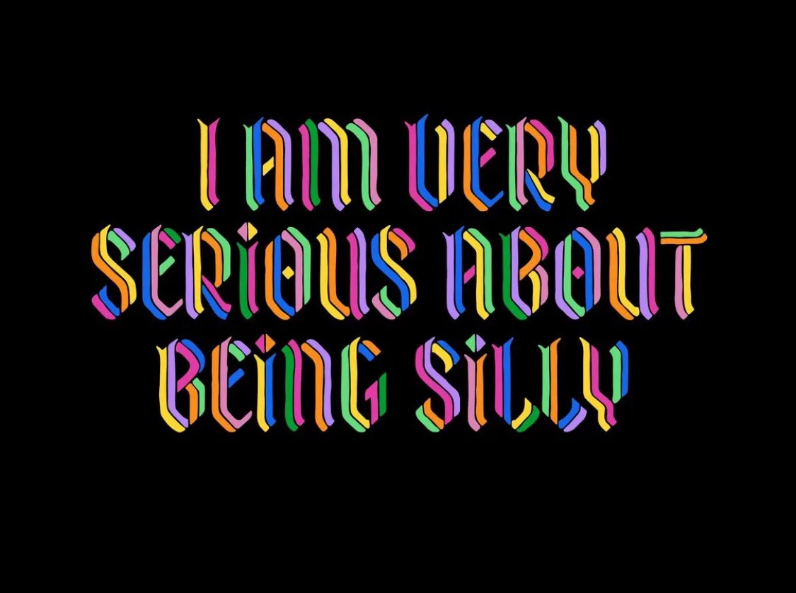 The image displays the text 'I AM VERY SERIOUS ABOUT BEING SILLY' in a bold, rainbow-colored, 3D-styled font against a solid…