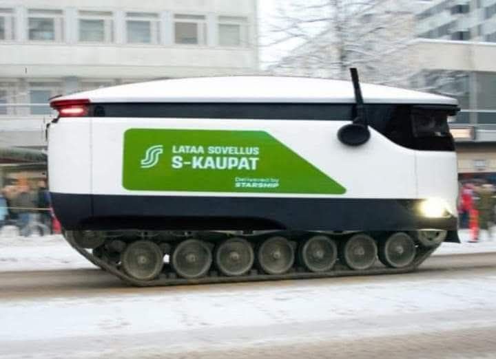 A white, tracked delivery vehicle with a green logo and text reading 'LATAA SOVELLUSS-KAUPAT' and 'Developed by STARSHIP' is…