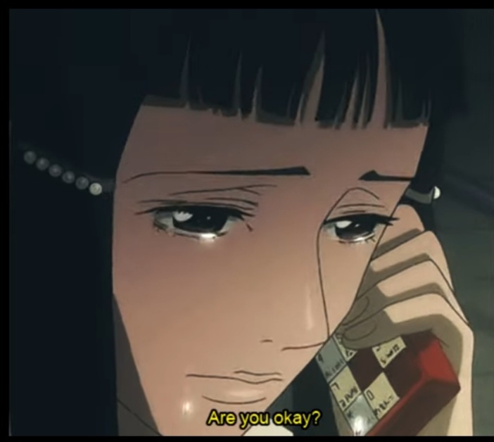 A close-up anime scene shows a woman with dark hair and a pearl earring holding a red rotary phone to her ear, her…