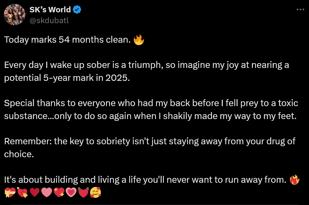 A screenshot of a tweet from 'SK's World' (@skdubatl) celebrating 54 months of sobriety. The text humorously acknowledges…