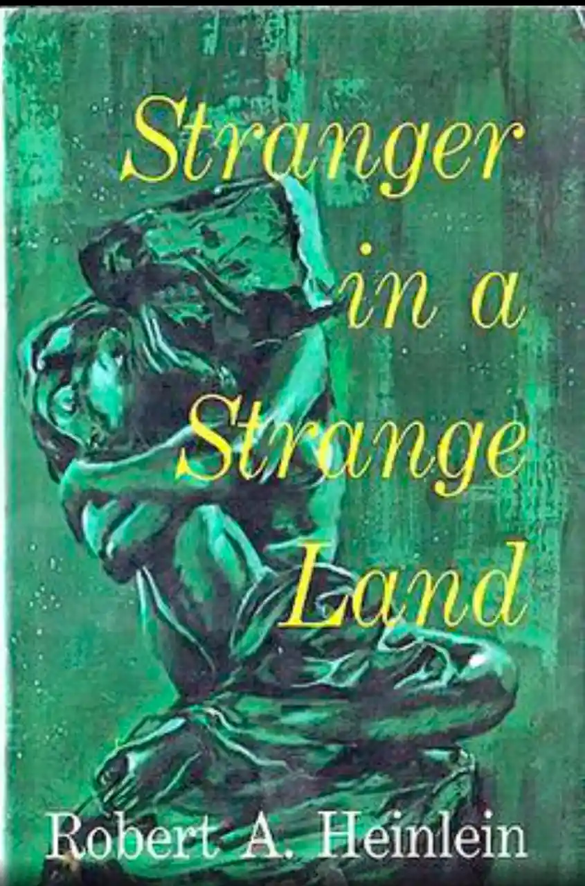 The image shows the cover of the book 'Stranger in a Strange Land' by Robert A. Heinlein, featuring a green-toned…