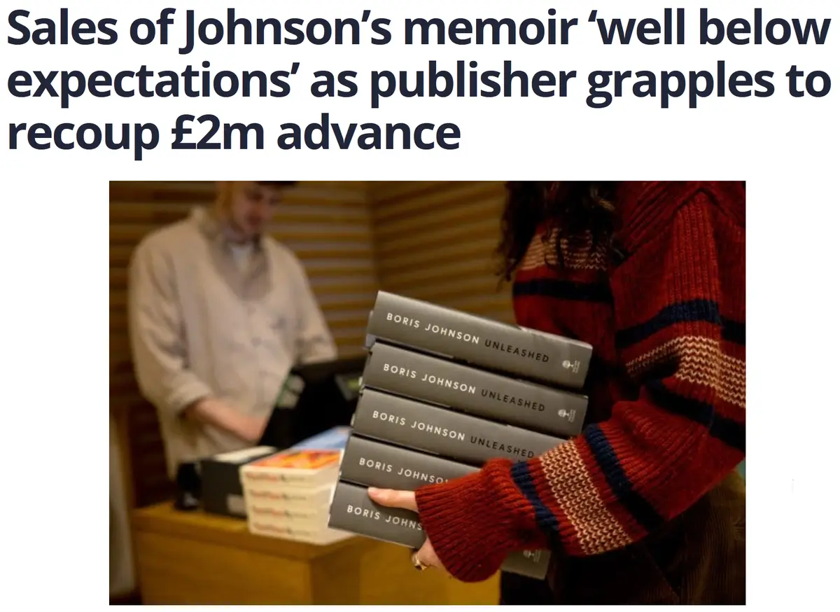 A person in a red sweater holds a stack of 'Boris Johnson Unleashed' memoirs at a bookstore checkout, while a blurred…