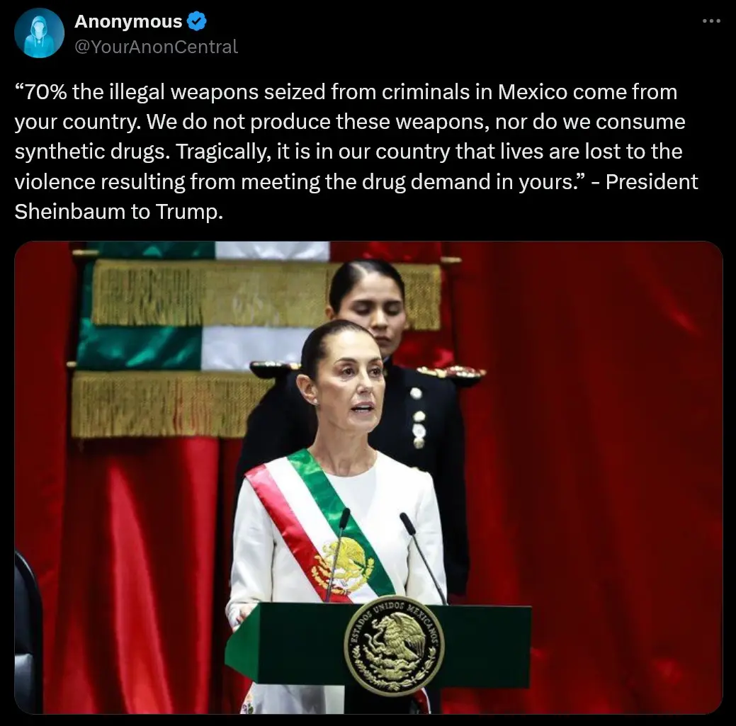 A woman in a white dress with a green, white, and red sash stands at a green podium bearing the Mexican coat of arms…