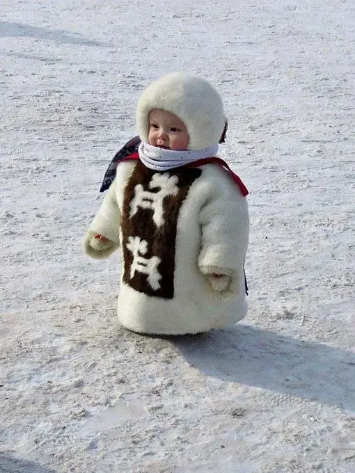 A Glimpse of Tradition: A Yakut Child in Winter Attire from Siberia