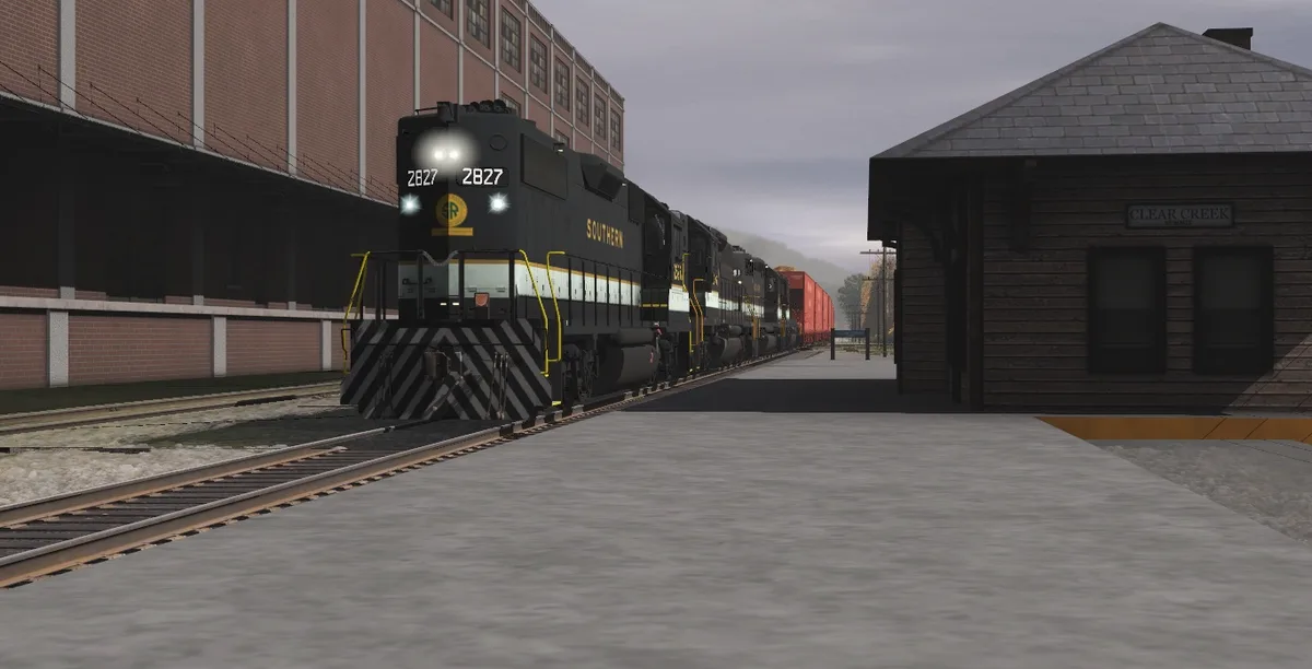 A black Southern Railway locomotive, numbered 2827, is shown approaching a station platform with its headlights on. The…