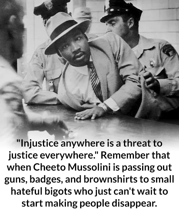 A black-and-white historical photo shows Martin Luther King Jr. seated at a table, flanked by two police officers. The image…
