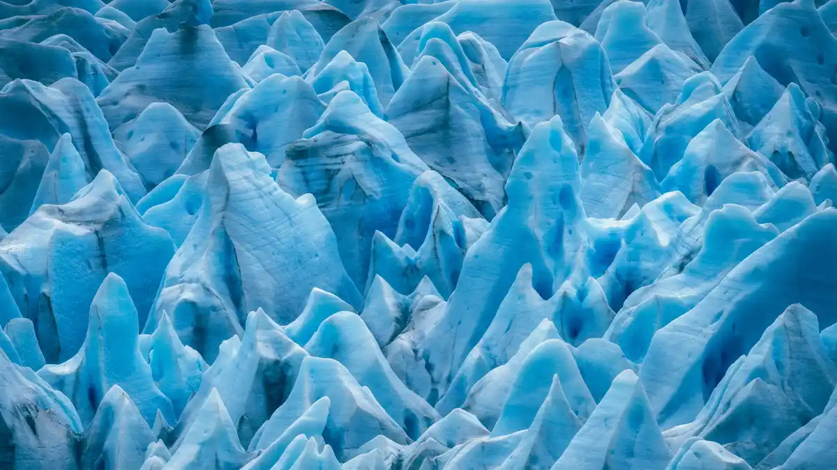 In this close-up, Chile's Grey Glacier shines a deep blue due to the absorption of red light by its crystalline structure…