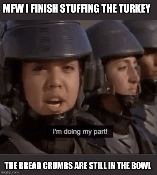 A still from a movie showing two people in military-style helmets and uniforms, one in the foreground looking shocked or…