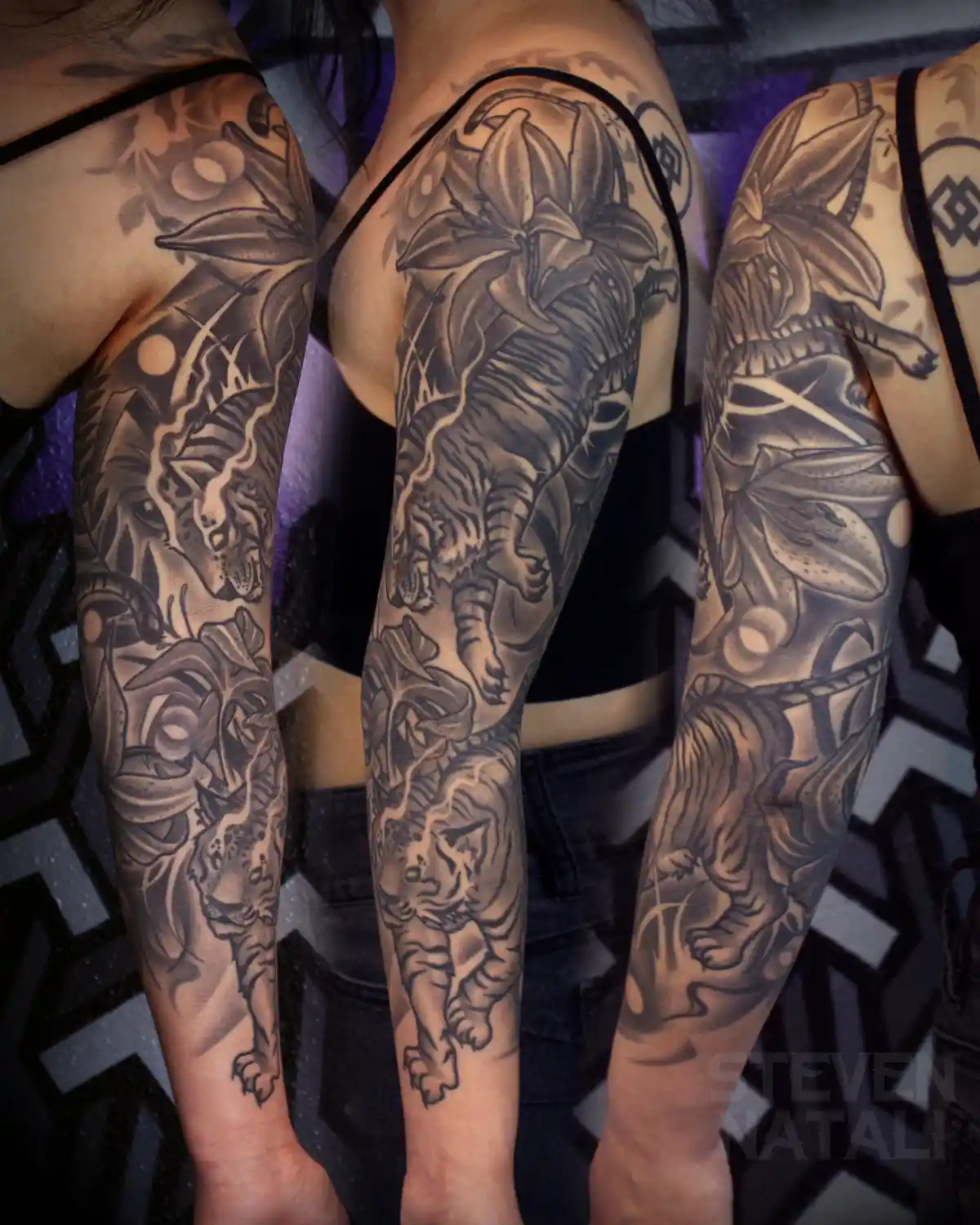 Three people show off their detailed black and grey sleeve tattoos featuring leopards, tigers, and large lily flowers…