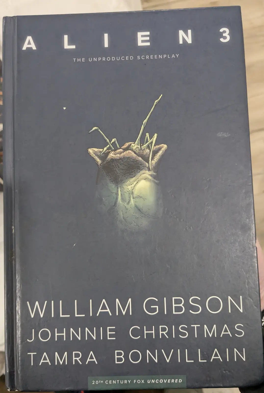 A dark blue book cover for 'Alien 3: The Unproduced Screenplay' by William Gibson, Johnnie Christmas, and Tamra Bonvillain…