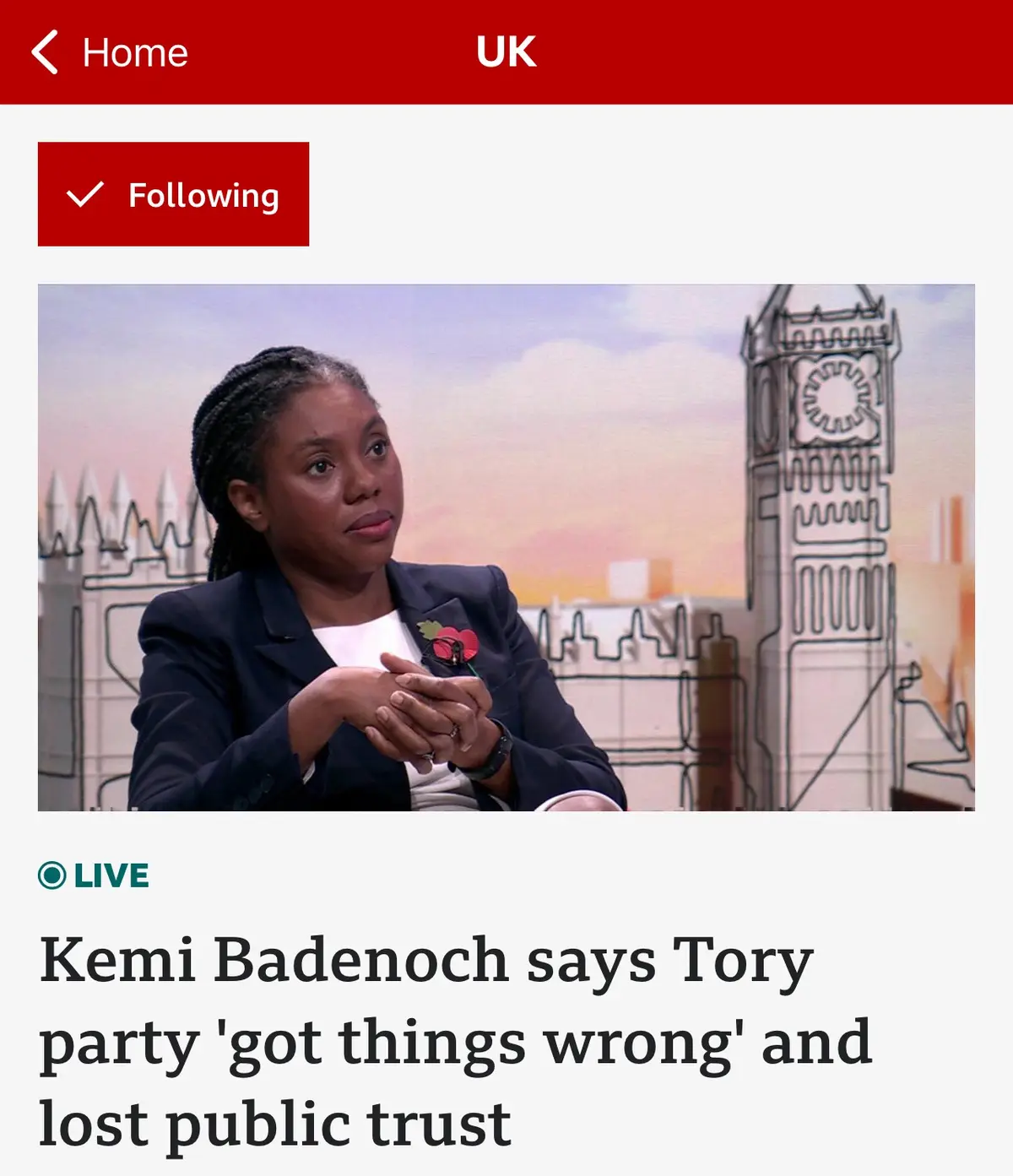 A screenshot of a news app showing a live UK news story with a photo of Kemi Badenoch. She is wearing a dark blazer with a…
