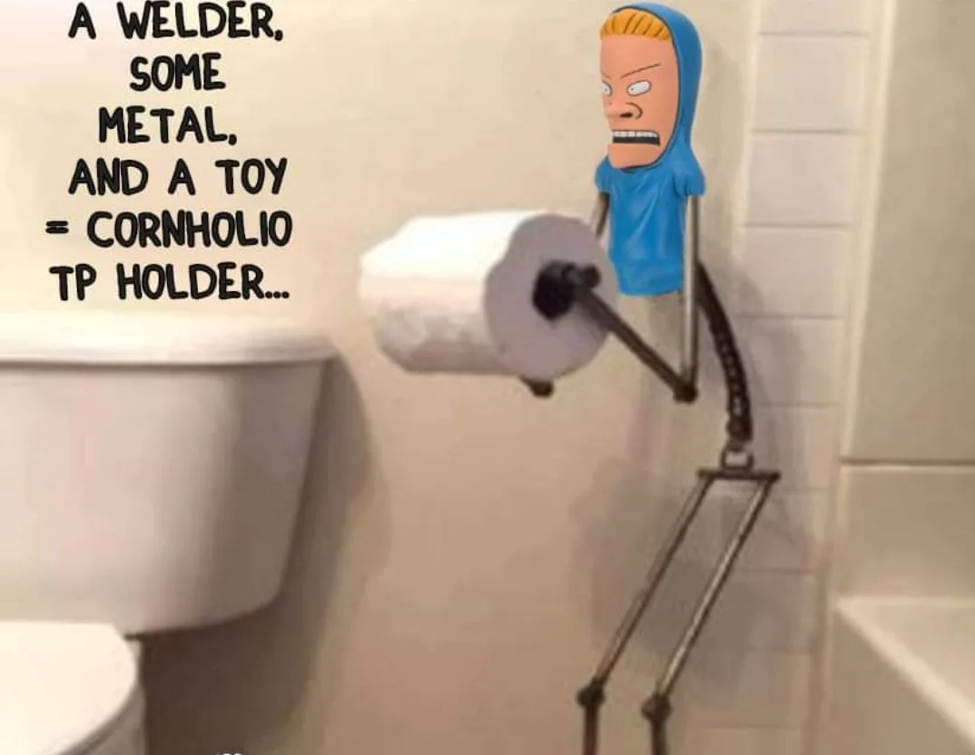 A bathroom scene shows a toilet paper holder with a roll of toilet paper, mounted on a tiled wall next to a toilet. The…