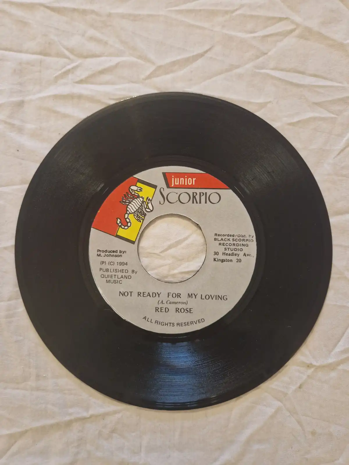 A close-up photo of a 7-inch vinyl record label for the song 'Not Ready For My Loving' by Red Rose, released under the…