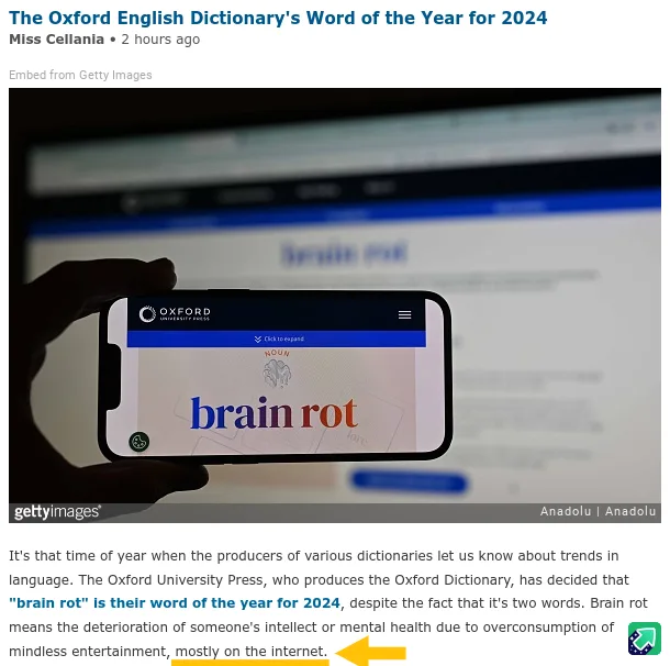 A hand holds a smartphone displaying the Oxford University Press website, which shows the word 'brain rot' in large blue and…