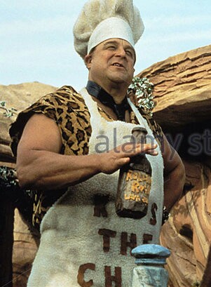 A man in a chef's hat and apron holding a bottle of what appears to be a sauce or condiment, with the text 'KISS THE CHEF'…