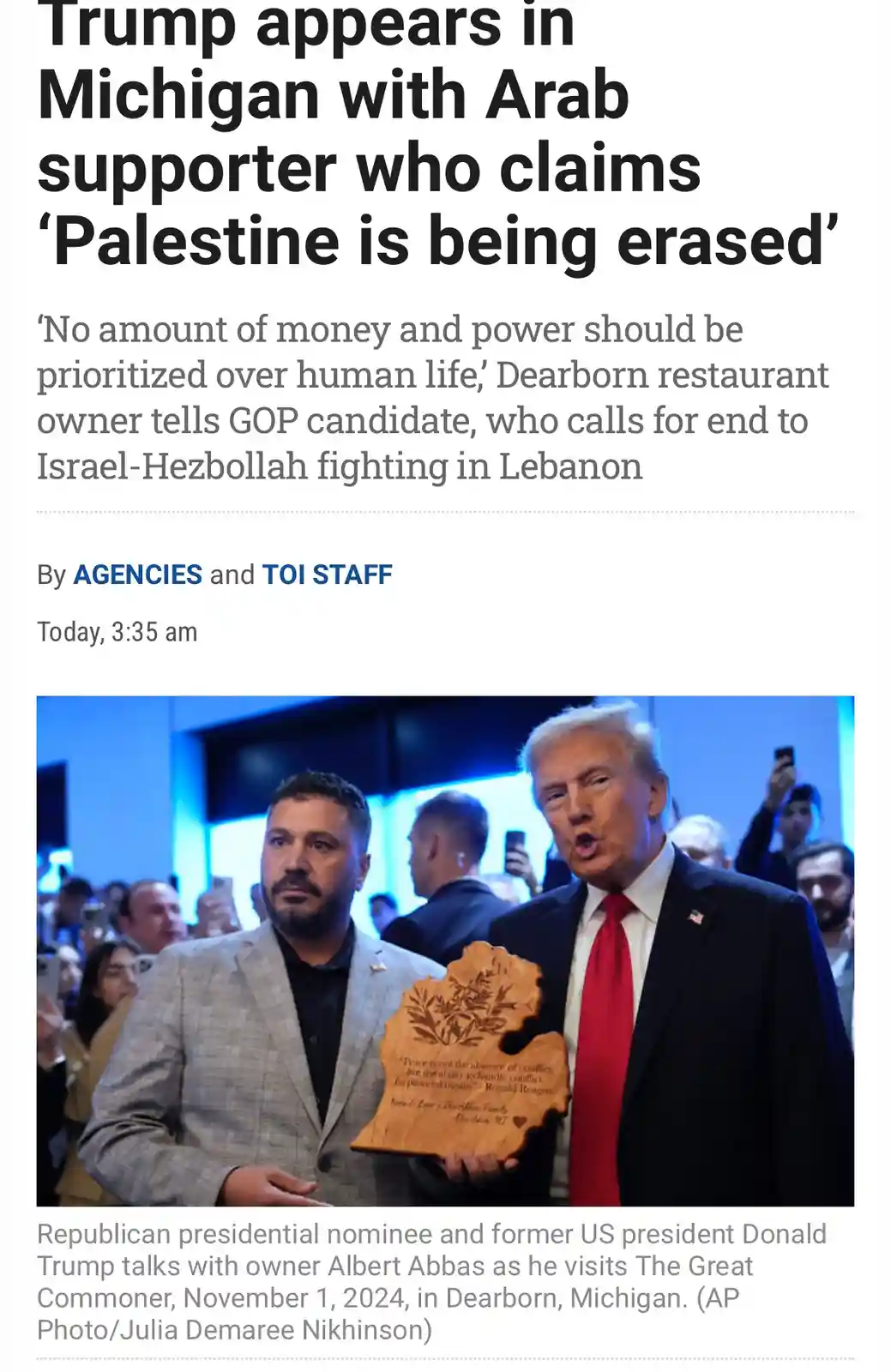 A screenshot of a news article shows Donald Trump standing next to a man holding a Michigan-shaped wooden plaque. The…