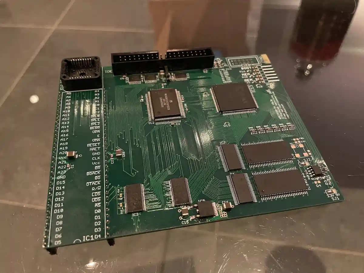 A close-up photo of a green computer motherboard with various chips, connectors, and labeled pins visible, resting on a…