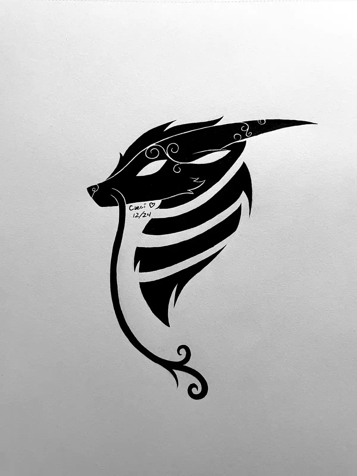 A black and white stylized drawing of a wolf's head with a long, flowing tail that curls into a decorative swirl, set…
