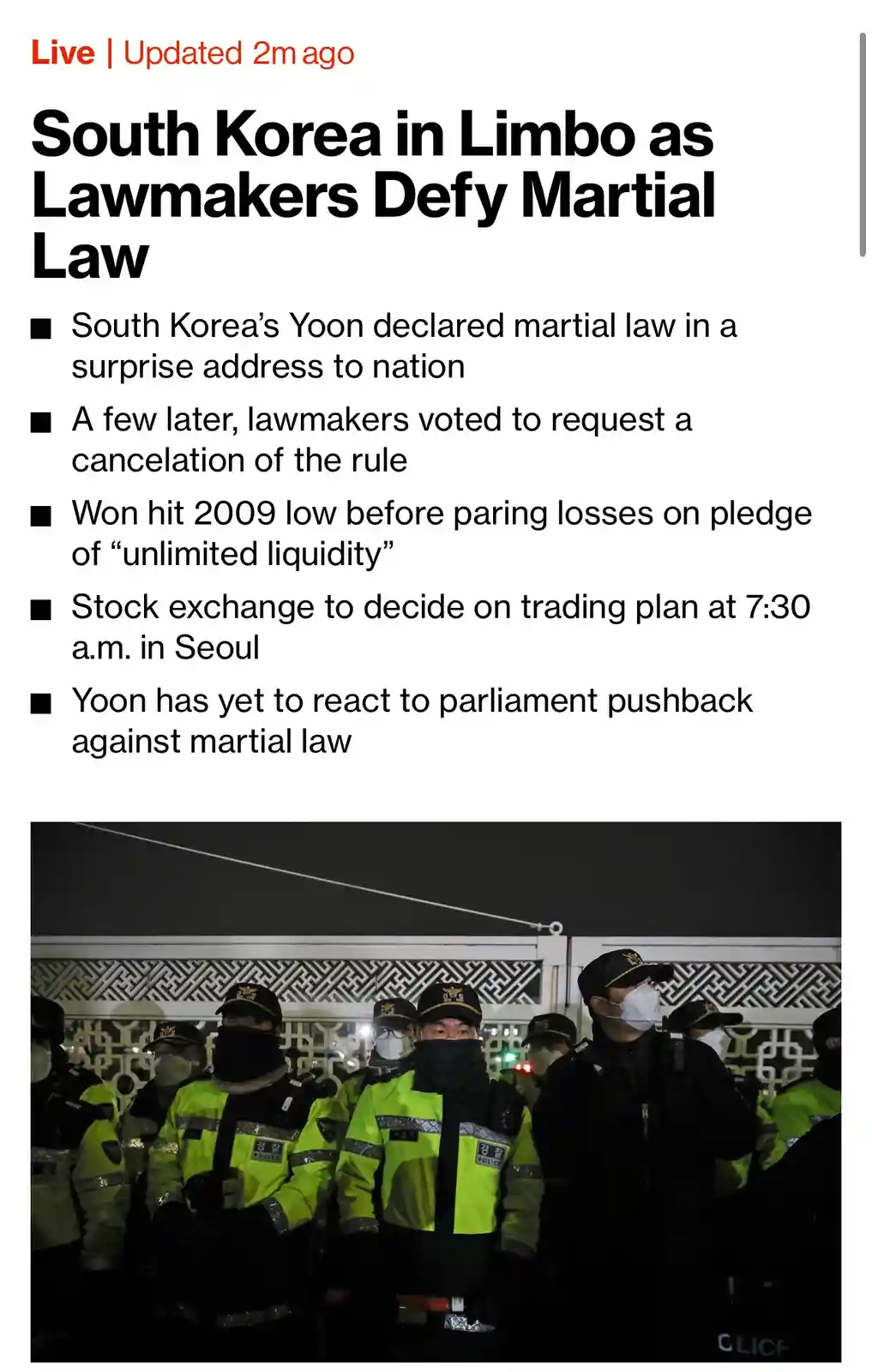 A screenshot of a news article with a headline about South Korea's political turmoil, featuring a photo of police officers…