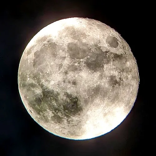 A close-up photograph of the moon against a black sky, showing its cratered surface and illuminated edge. Overlaid text in…