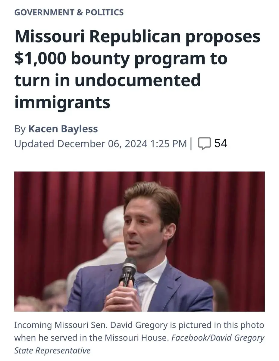 A screenshot of a news article shows a photo of a man in a blue suit speaking into a microphone in front of red curtains…
