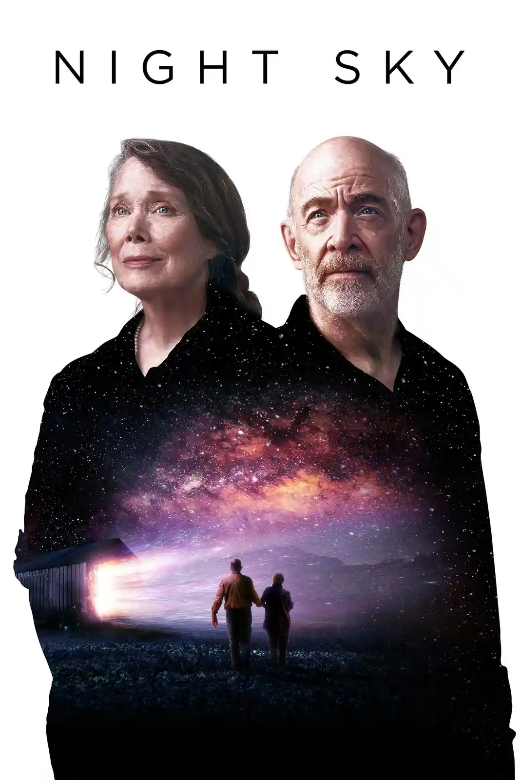 The image is a promotional poster for the TV show 'Night Sky,' featuring two elderly actors, a man and a woman, looking…