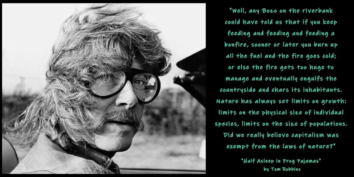 A black-and-white photo of a man with long hair, glasses, and a mustache looking out a car window. Overlaid text is a quote…