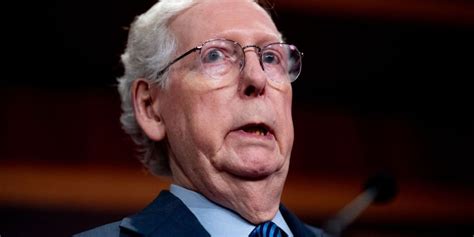 a close-up photo of senator chuck grassley, an older white man with white hair and glasses, wearing a suit and tie, looking…