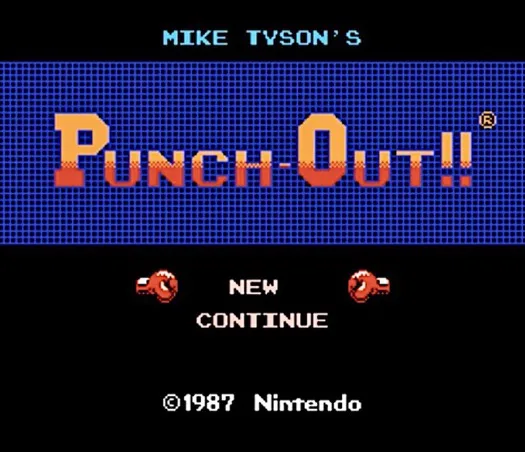 The title screen of the 1987 Nintendo game 'Mike Tyson's Punch-Out!!' shows the game's title in large pixelated orange…