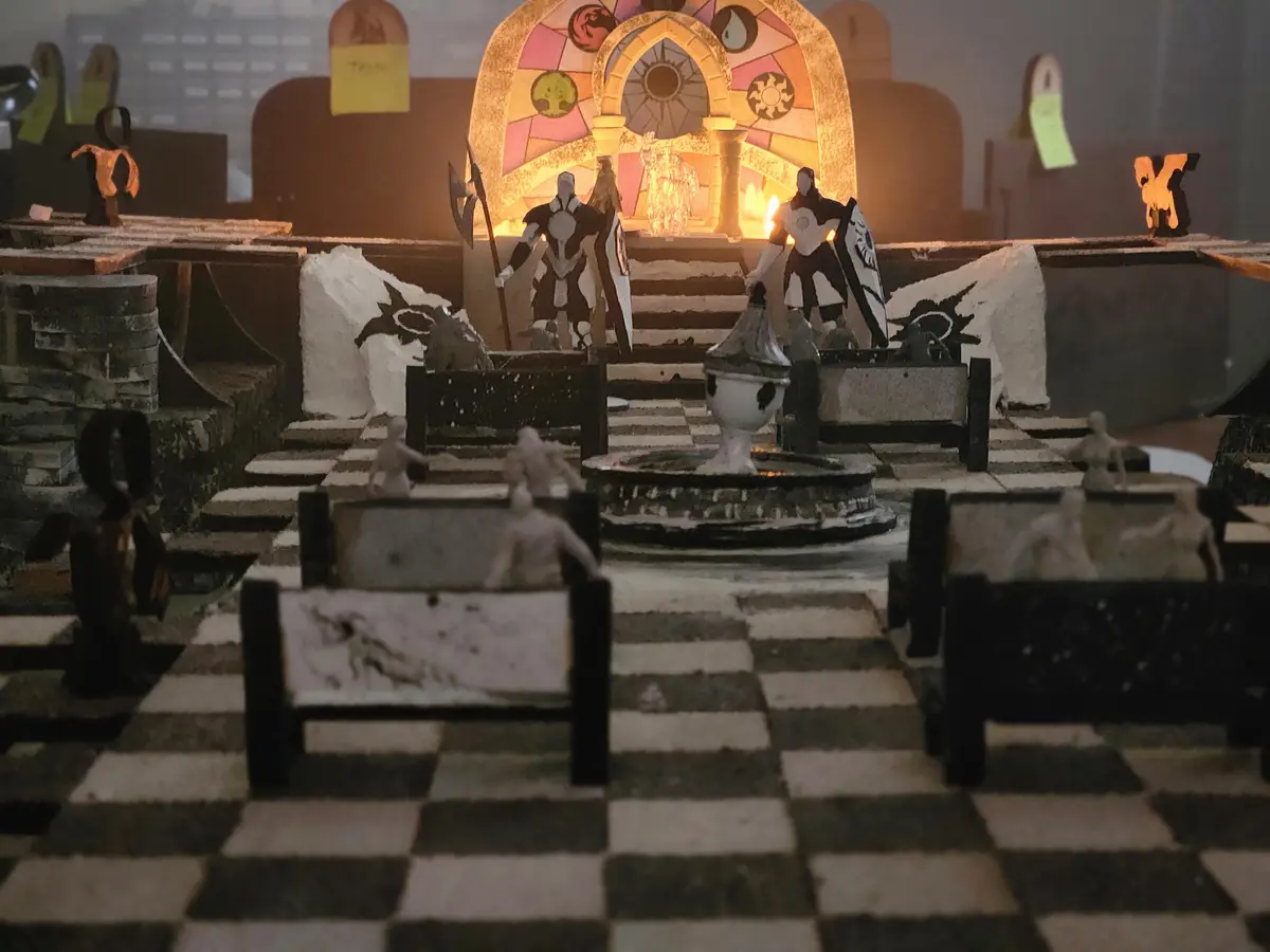 A handmade diorama of a chessboard with miniature figures, where the pieces are stylized fantasy warriors and monsters. The…
